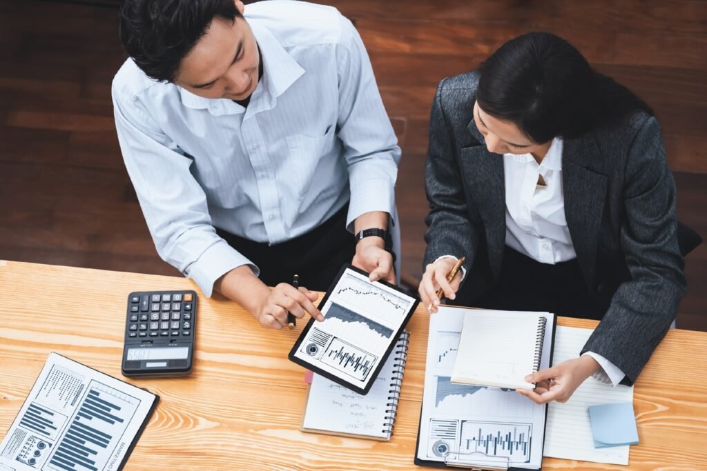 Top view multiracial analyst team use BI dashboard for data analysis. Concord